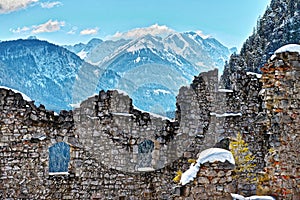 Structure of castle ruin wall in snowy alpine landscape by vast view