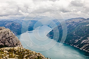 Panoramic mountain view to the long narrow and blue Lysefjord, Prekestolen hiking trail, Forsand, Rogaland county, Norway