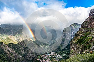 Panoramic mountains view from Eira do Serrado viewpoint with rainbow above the Nun`s Valley on Madeira Island Portugal photo