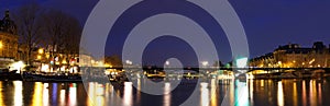 The panoramic night view of Seine river during the night with famous bridge Pont des Arts, Paris, France.