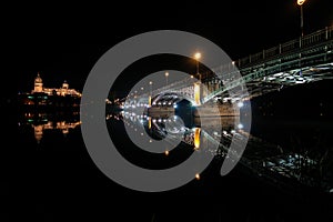 Panoramic night wide view of the historic city of Salamanca with New Cathedral and Enrique Esteban bridge. Castile and Leon in photo