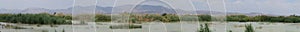 Panoramic of one of the lagoons with mountains in the background of the El Hondo natural park photo