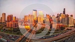 Panoramic perspective of Chicago`s West Loop during golden hour with traffic.