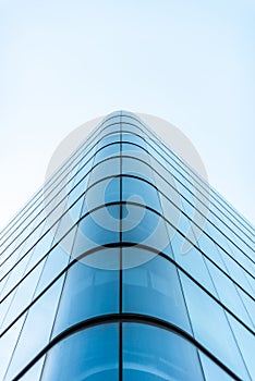 Panoramic and perspective wide angle view to steel light blue background of glass high rise building skyscraper commercial modern