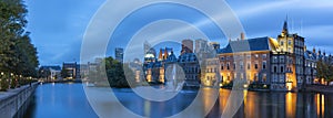 Panoramic photo during the blue hour on a windy autumn day of the Hofvijver and the Binnenhof with the parliament buildings in The