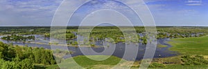 Panoramic photo. Horizontal landscape: the river flooded the valley. River and the field on a sunny summer day