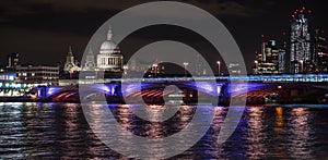 Panoramic photo of the London skyline at night, showing The River Thames, Blackfriars Bridge and St Paul`s Cathedral