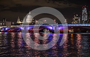 Panoramic photo of the London skyline at night, showing The River Thames, Blackfriars Bridge and St Paul`s Cathedral