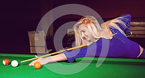Panoramic photo lovely blonde girl playing on the pool table