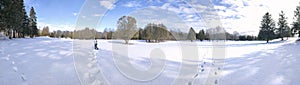 Panoramic photo of the public park on deep snow with footprint for a winter weather concept