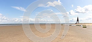 Panoramic photo of a sandy beach on the North Sea in Cuxhaven, Germany. Northernmost point of Lower Saxony. Seascape at low tide