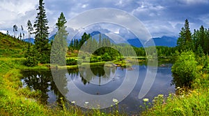 Panoramic picture of beautiful mountain lake Strbske Pleso at summer evening.