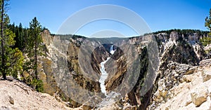 Panoramic picture of the lower falls waterfall on a sunny day in the yellowstone national park, wyoming, united states of america