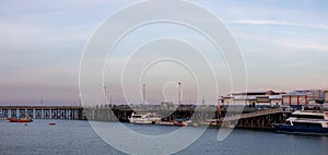 Panoramic picture of a pier and the Wharf in the city of Darwin, Northern Territory, Australia. Boats and beach near the city.