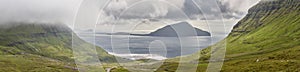 Panoramic picturesque green turf hills and atlantic ocean. Faroe islands