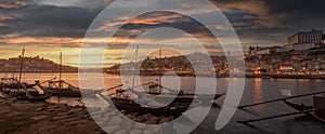 Panoramic of Porto cityscape in sunset with river on the front and wine carrier ship in  foreground and city of Porto in