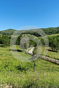 Old wooden fence along the dirt rural road