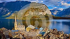 Panoramic scenic view of Austrian alps. Hallstatt mountain village at Hallstatt lake. Sunny day lake view on Hallstatt alps