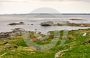 A panoramic scenic view to Fjoloy fort site and lighthouse from the top of the hill