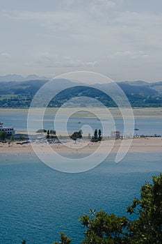 Panoramic shot of a beach with a cloudy day background