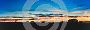 Panoramic shot of beautiful sunset over a field in Santa Fe, New Mexico