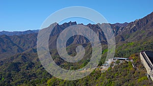 Panoramic shot of the China Great wall that rises up the side of the mountain in a begining of fall