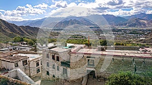 Panoramic shot of the city of Lhasa stretching towards the rocky Himalaya.