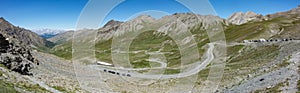 Panoramic shot of Col Agnel mountain pass between France and Italy with cars under clear blue skies