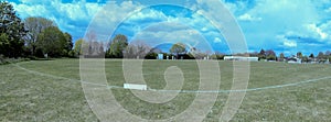 A panoramic shot of cricket being played in New Bradwell Park