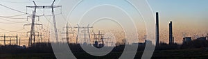 Panoramic shot of Enel Energie's power lines during a sunset in Bucharest, Romania