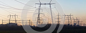 Panoramic shot of Enel Energie's power lines during a sunset photo