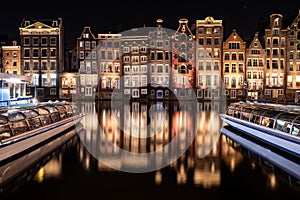 Panoramic shot of the illuminated colorful buildings along Canal Singel at night