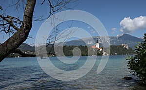 Panoramic shot of the lake Bled in Slovenia with small Pilgrimage Church on a clear sky background