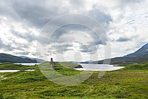 Panoramic shot of Loch Assynt with the ruins of Ardvreck Castle in north west Scotland