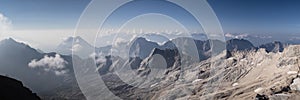 Panoramic shot of majestic mountain tops with blue skies in the background