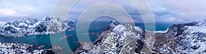 Panoramic shot over Norway Lofoten aerial landscape in winter time with rainbow and mountains covered in snow