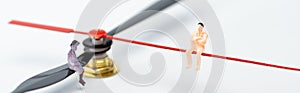 Panoramic shot of people figures on pointers of clock on white surface photo