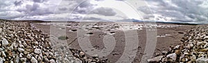 Panoramic shot of the sandy Morecambe Bay in the UK under the cloudy sky