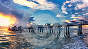 A panoramic shot of a scenic colorful sunset at the beach - Naples Pier, Florida