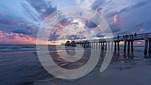 A panoramic shot of a scenic colorful sunset at the beach - Naples Pier, Florida, USA