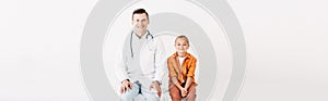 Shot of smiling pediatrist and child isolated on white photo
