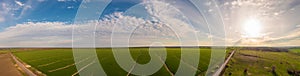 Panoramic shot of soil erosion caused by water, aerial view of a green field at day time