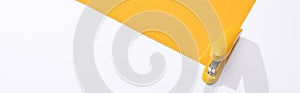 Panoramic shot of stapler and yellow paper on white background.