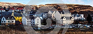 Panoramic shot of a town with residential houses and cars in Isle of Skye, Scotland, UK