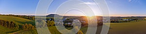 Panoramic shot of a village and raps field during the sunrise in Mildenau, Germany