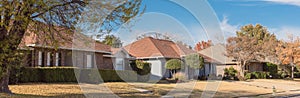 Panoramic single story bungalow houses in suburbs of Dallas with bright fall foliage colors