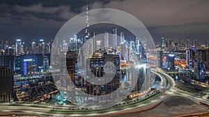 Panoramic skyline of Dubai with business bay and downtown district all night timelapse.