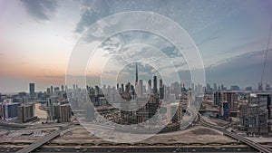 Panoramic skyline of Dubai with business bay and downtown district day to night timelapse.