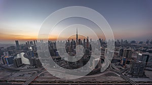 Panoramic skyline of Dubai with business bay and downtown district day to night timelapse.