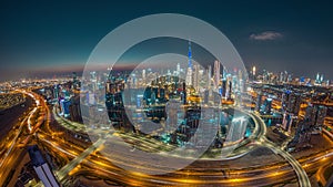 Panoramic skyline of Dubai with business bay and downtown district day to night timelapse.